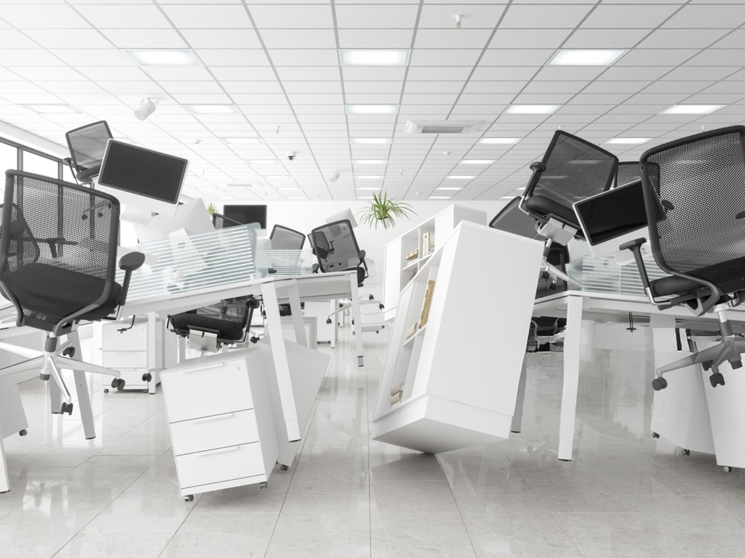 An office space with a removed desk ready for disposal.