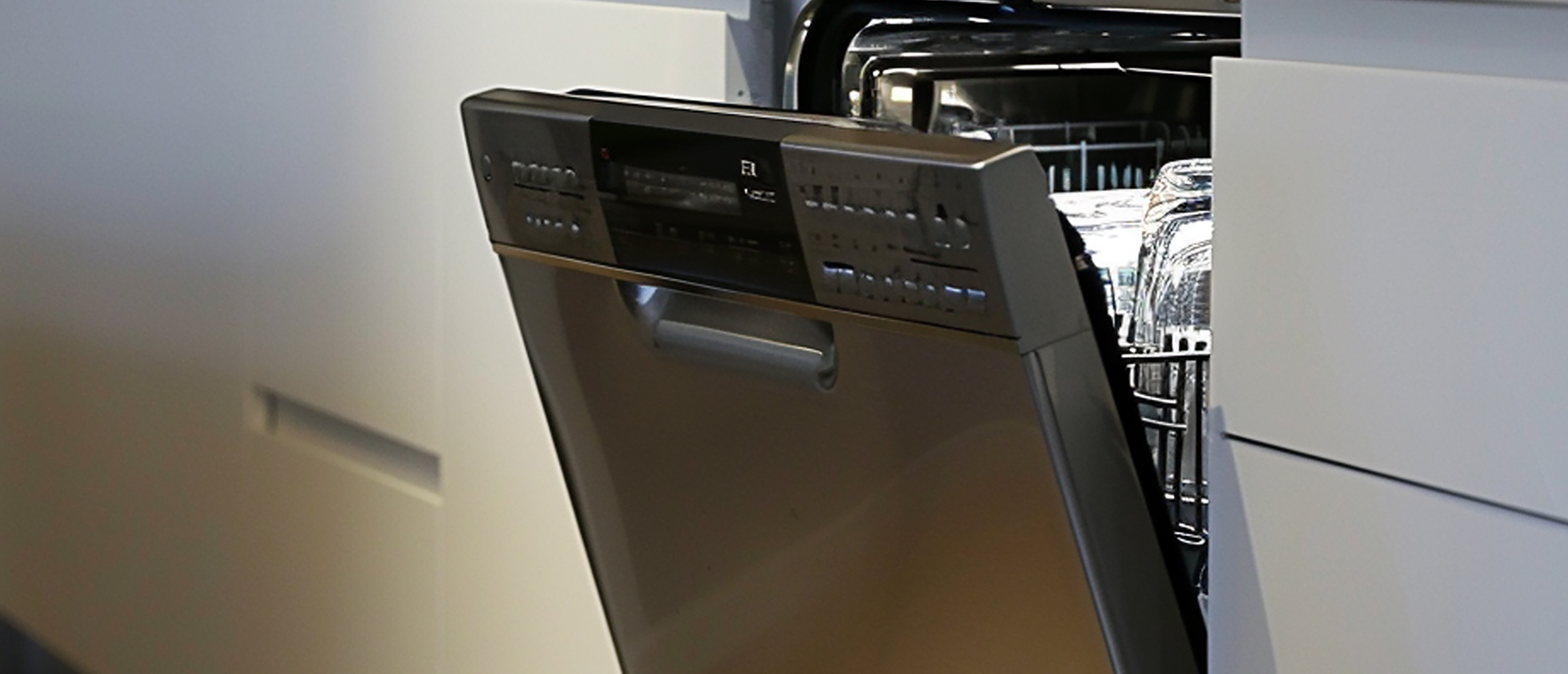 An empty kitchen with a removed dishwasher, ready for disposal.