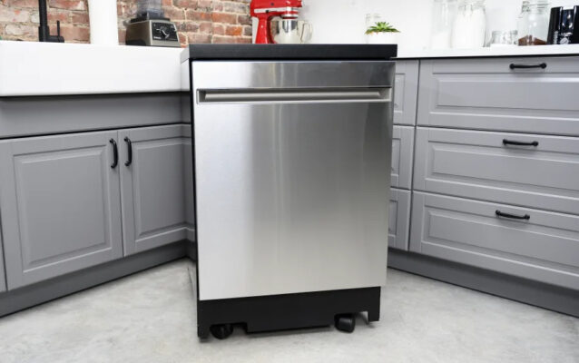 An empty kitchen with a removed dishwasher, ready for disposal.
