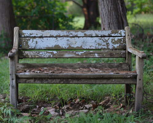 Empty bench being removed from a park.
